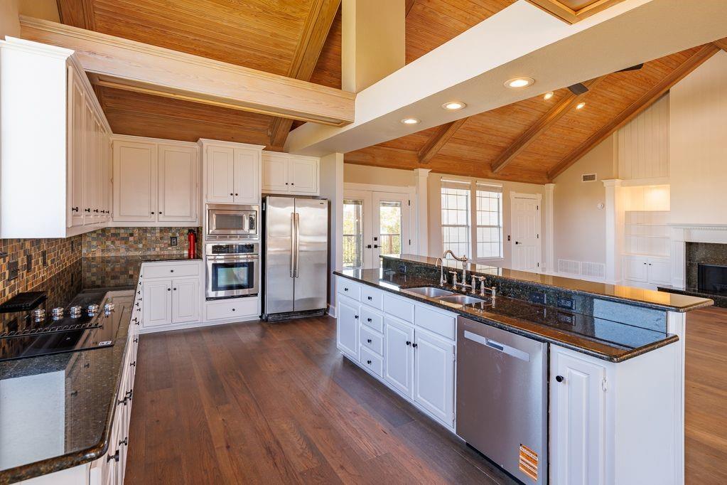 11507 Clipper Circle Frisco, TX 75036 - Photo 16 of 40 a kitchen with stainless steel appliances granite countertop a stove a sink and a refrigerator