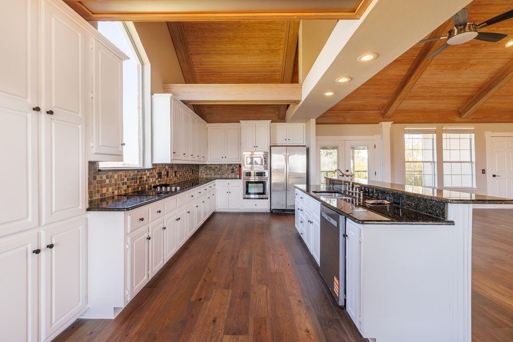 11507 Clipper Circle Frisco, TX 75036 - Photo 18 of 40 a large kitchen with stainless steel appliances granite countertop a stove and a large window
