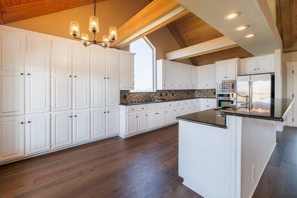 11507 Clipper Circle Frisco, TX 75036 - Photo 19 of 40 a kitchen with granite countertop a sink cabinets and wooden floor