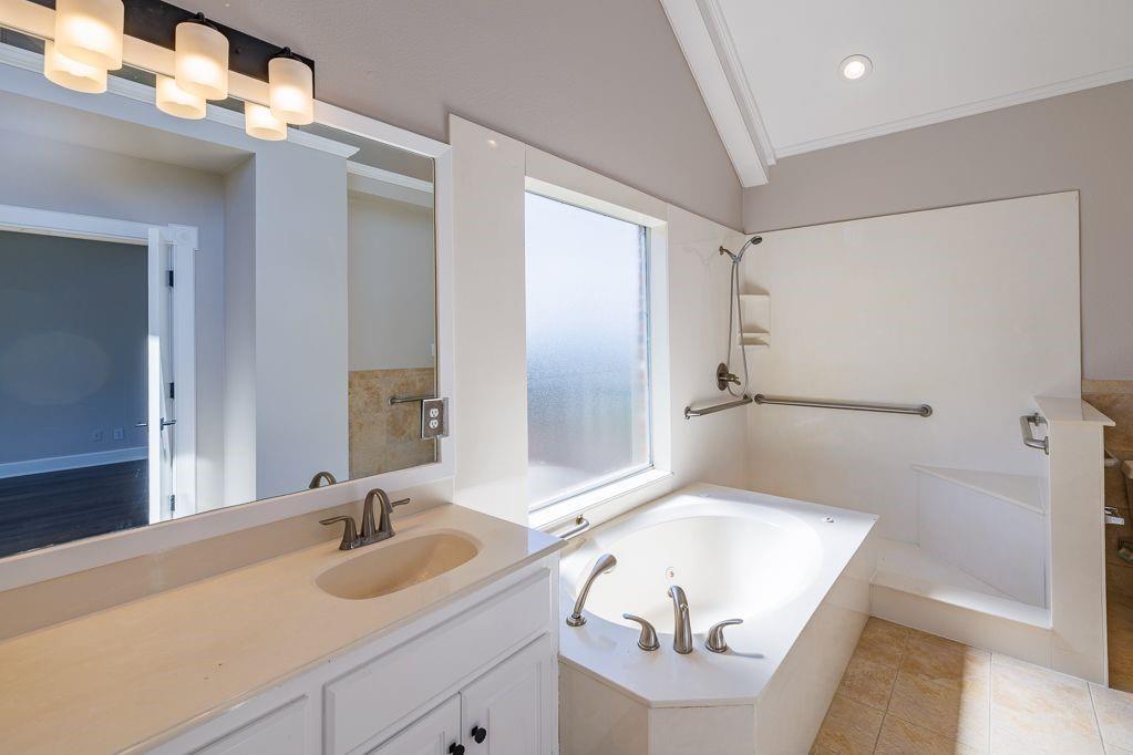 11507 Clipper Circle Frisco, TX 75036 - Photo 21 of 40 a bathroom with a tub sink and mirror