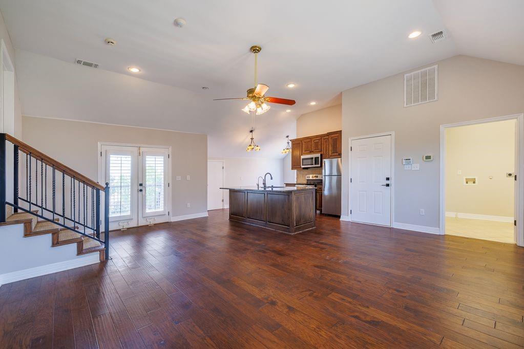 11507 Clipper Circle Frisco, TX 75036 - Photo 40 of 40 a view of an empty room with wooden floor and a kitchen