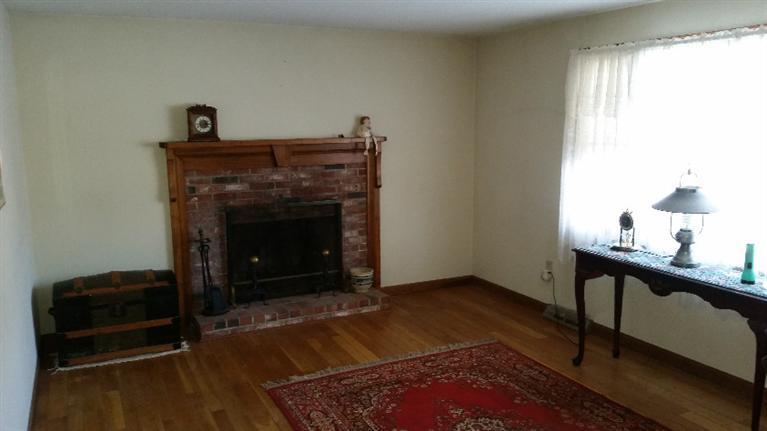 108 Clay Pond Road Bourne, MA 02532 - Photo 2 of 4 a living room with furniture and a fireplace