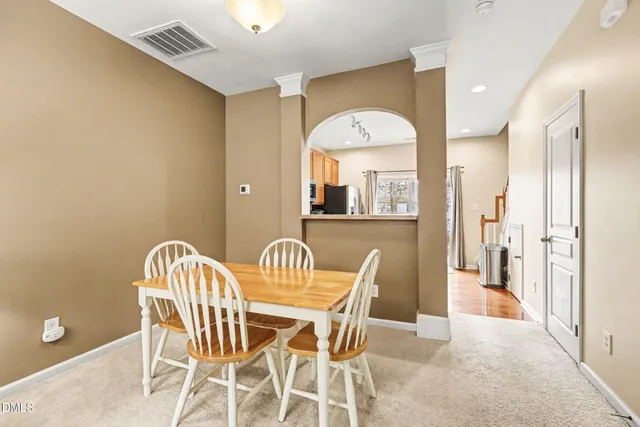 a view of a dining room with furniture and a chandelier
