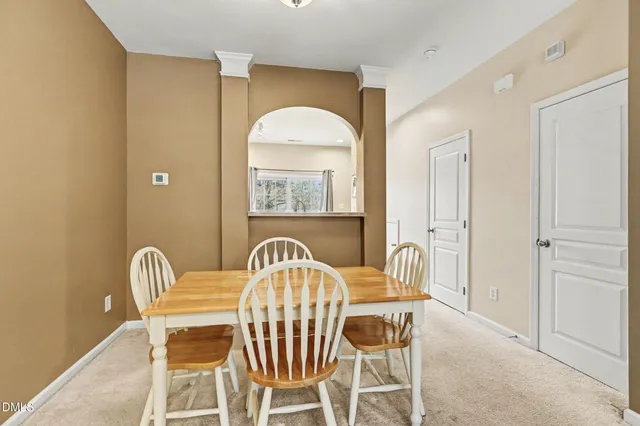 a view of a dining room with furniture and chandelier