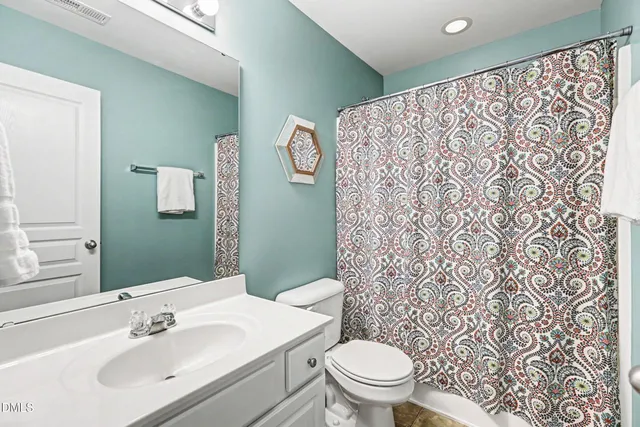 a bathroom with a sink toilet and mirror