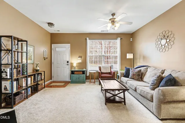 a living room with furniture and a chandelier