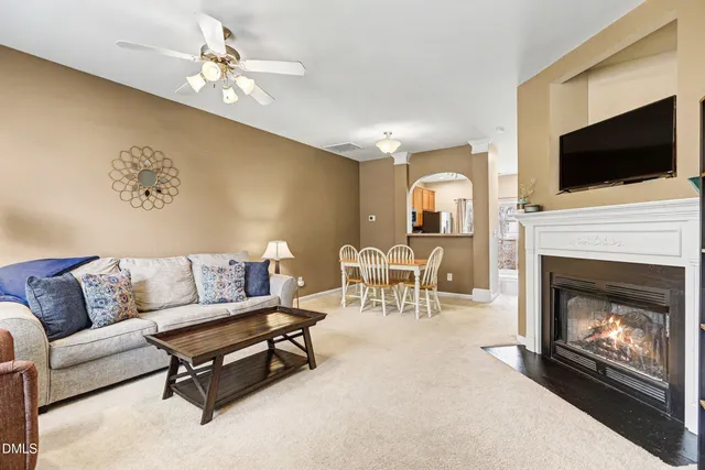 a living room with furniture fireplace and flat screen tv