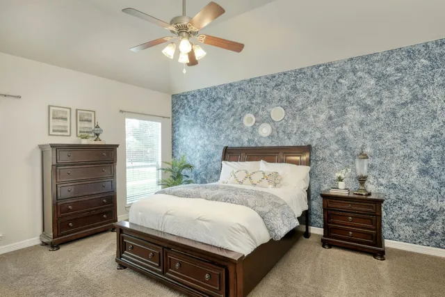 a bathroom with a granite countertop sink a toilet and shower