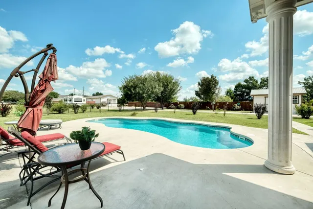a view of house with garden space and car parked
