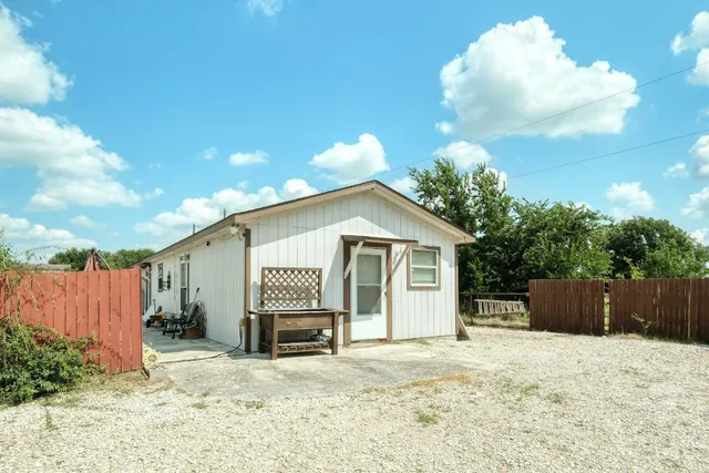 a kitchen with granite countertop a sink stove and refrigerator