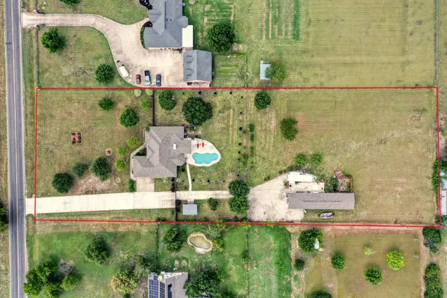 an aerial view of residential houses with outdoor space