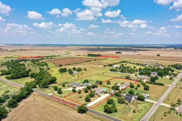 a view of a street with a yard in front of it