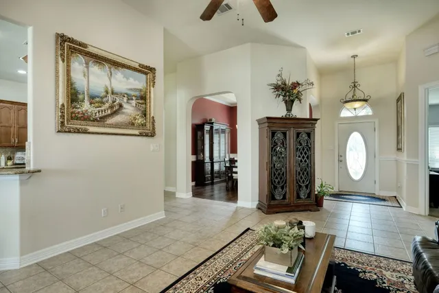 a dining room with furniture and chandelier