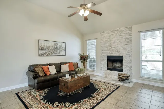 a living room with furniture and a fireplace