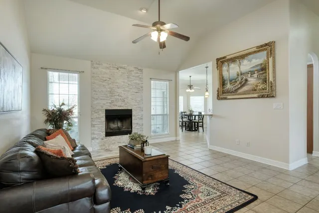 a dining room with wooden floor a chandelier a wooden table and chairs