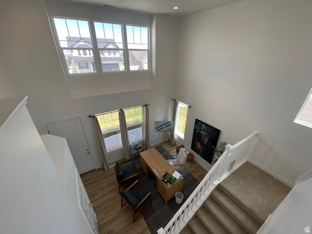 341 Quartz Road, Unit 8037 Tooele, UT 84074 - Photo 3 of 10 Two-story foyer featuring high ceilings, white walls, and wood-finish flooring in the lower level