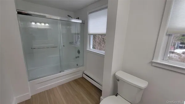 a bathroom with a shower and toilet