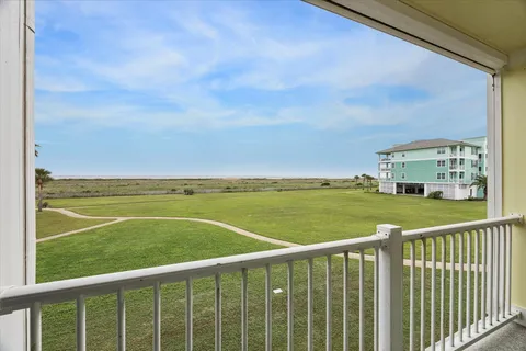 a view of a balcony with table and chairs
