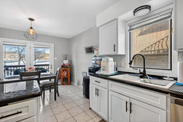 a kitchen with stainless steel appliances granite countertop a sink and a stove