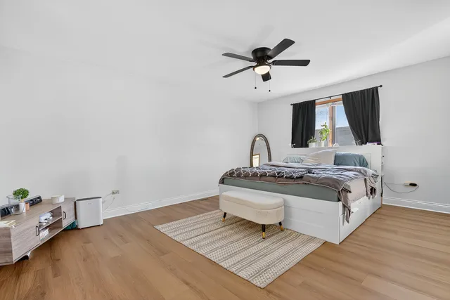 a living room with a bed furniture and a flat screen tv