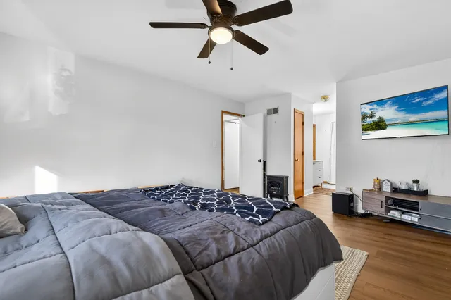 a bedroom with a bed and a chandelier