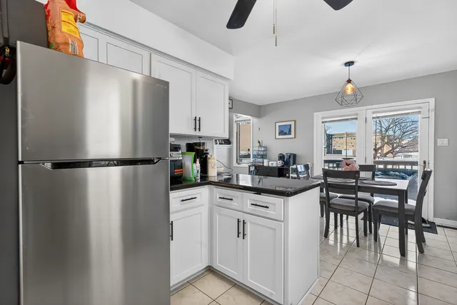 a kitchen with white cabinets and white appliances