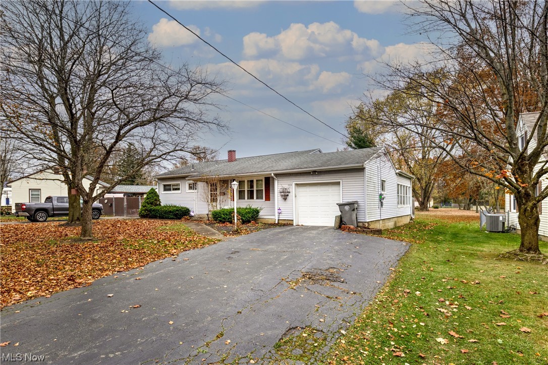 View of front facade with a garage and a front lawn