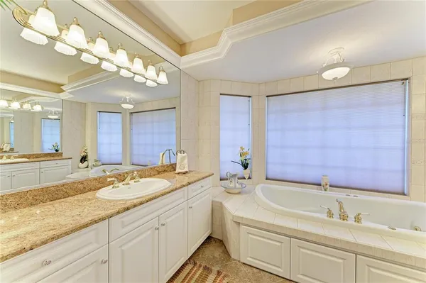 a bathroom with a granite countertop sink mirror and vanity