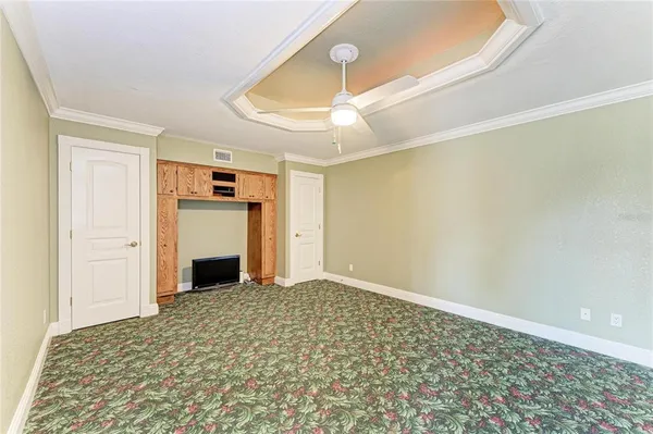 a view of a house with a yard and potted plants