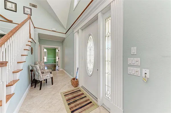 a living room with furniture a large window and a fireplace