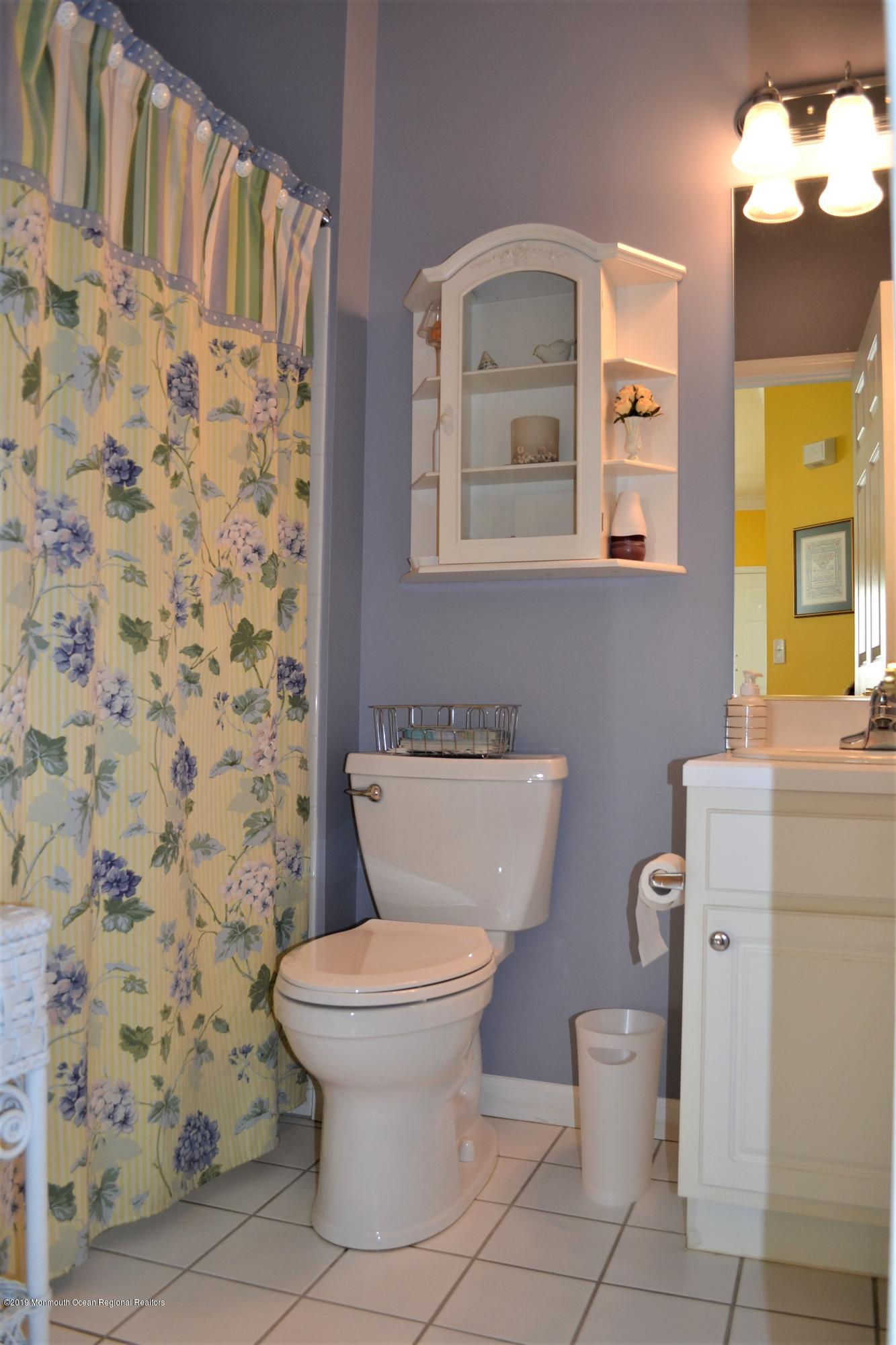 143 Wordsworth Road Brick, NJ 08724 - Photo 25 of 41 a bathroom with a toilet a sink and a mirror