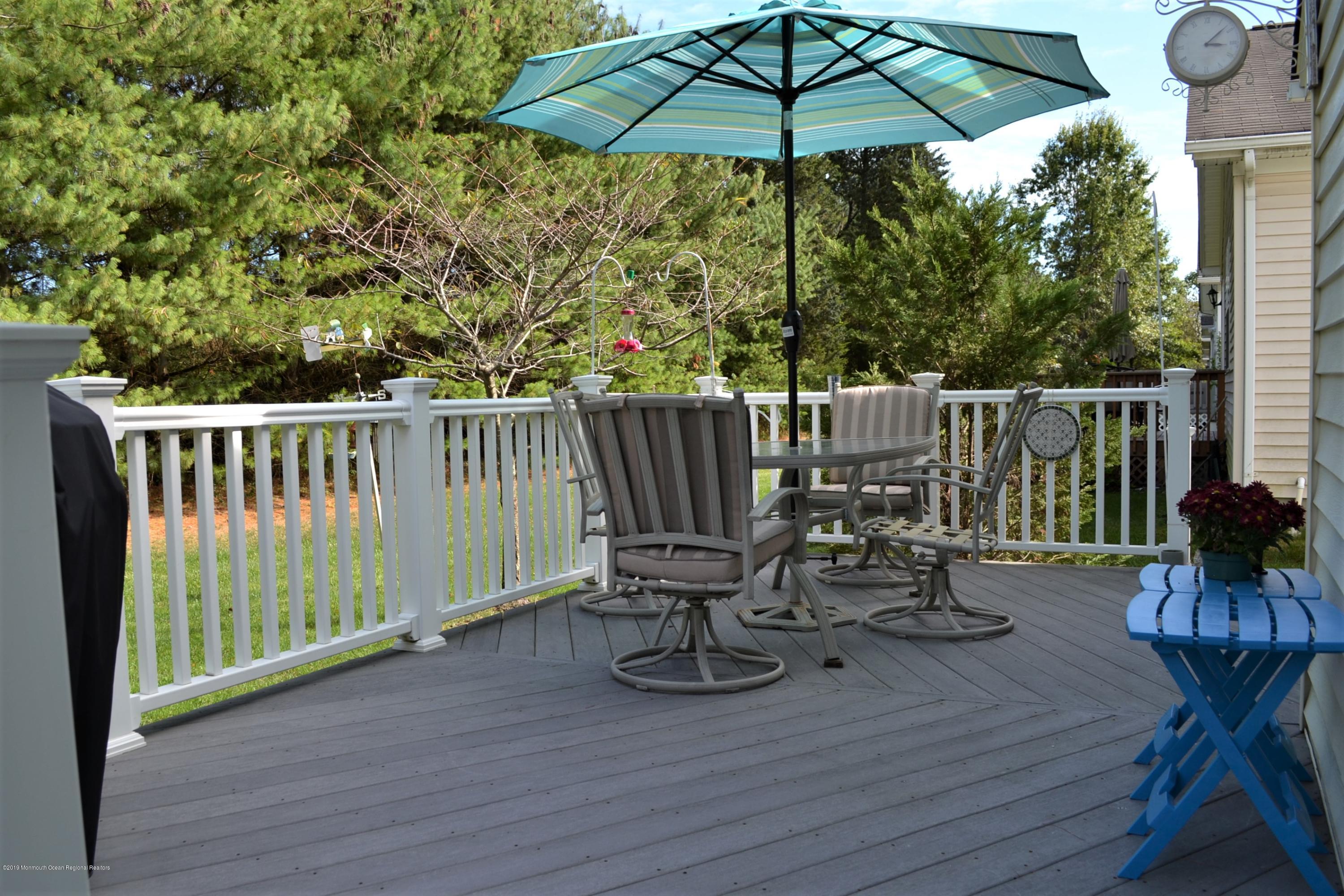 143 Wordsworth Road Brick, NJ 08724 - Photo 33 of 41 a view of balcony with furniture and umbrella