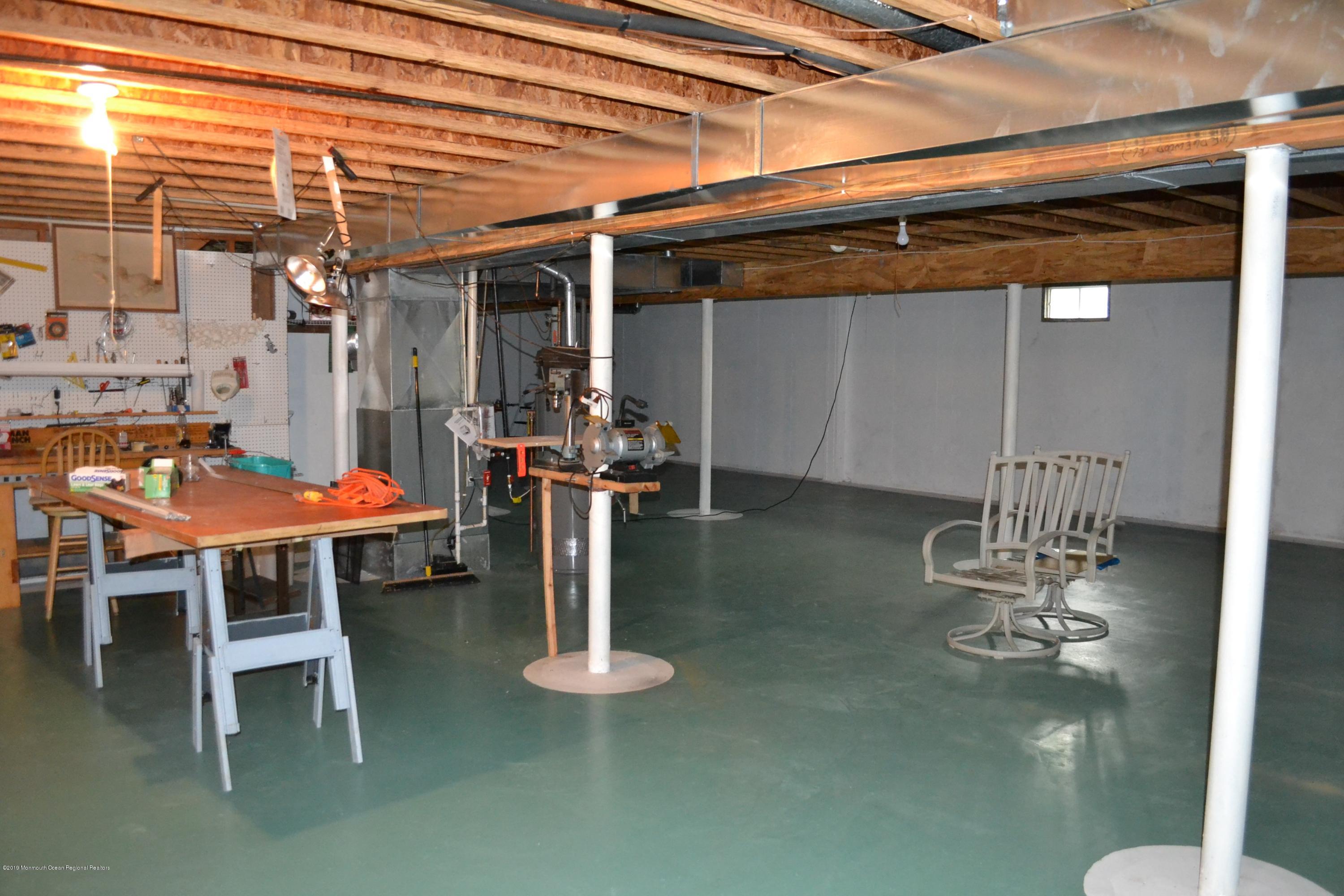 143 Wordsworth Road Brick, NJ 08724 - Photo 36 of 41 a dining room with furniture and a chandelier