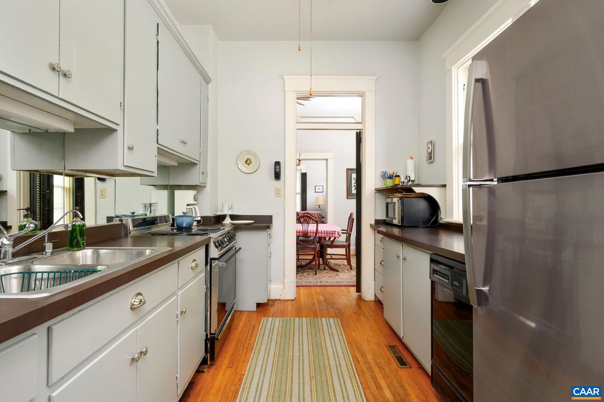 211 Robertson Avenue Charlottesville, VA 22903 - Photo 11 of 28 a kitchen with stainless steel appliances a refrigerator sink and stove