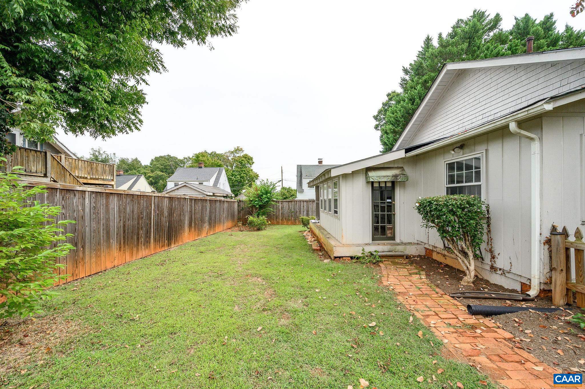 211 Robertson Avenue Charlottesville, VA 22903 - Photo 25 of 28 a backyard of a house with plants and wooden fence