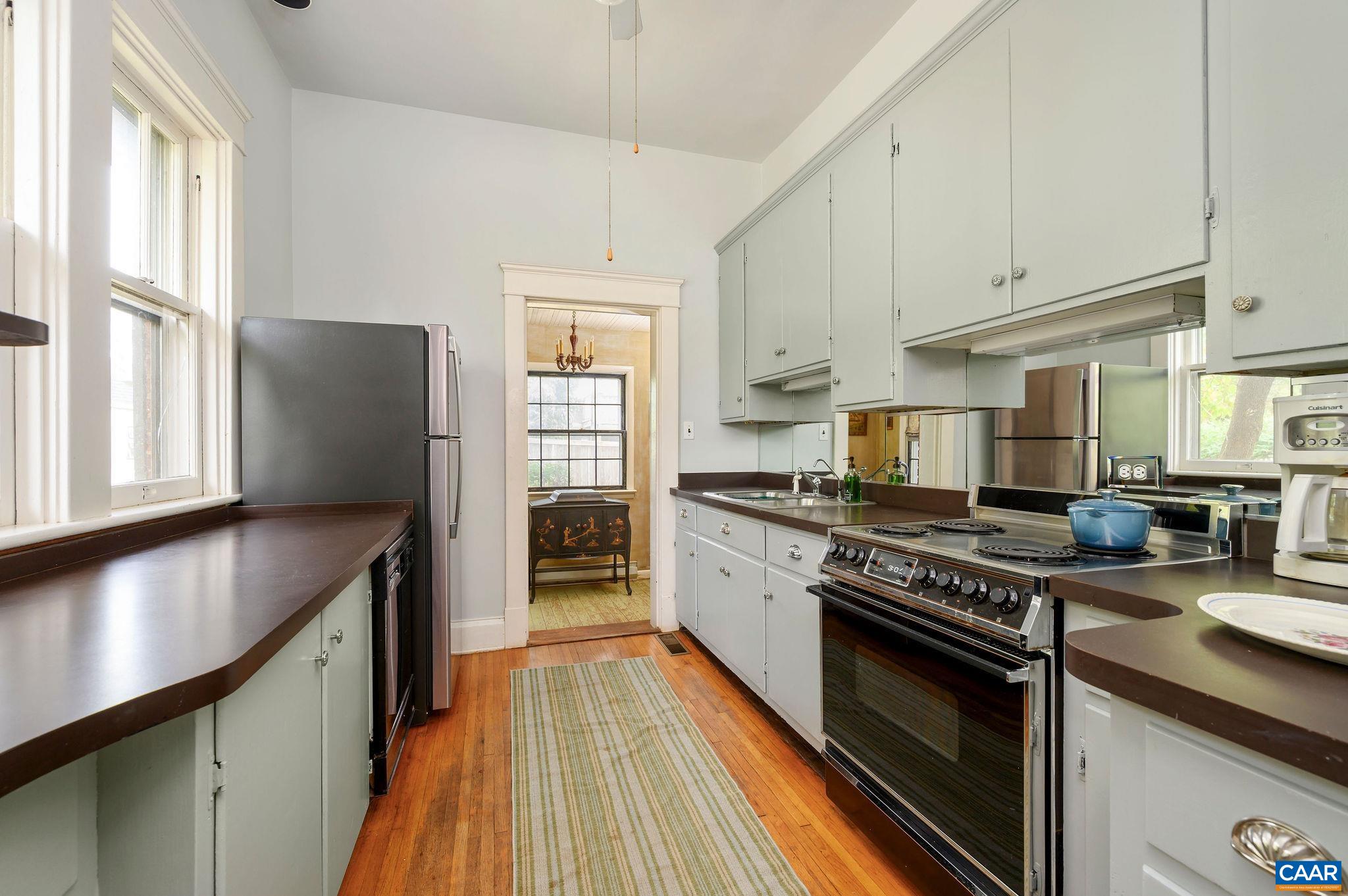 211 Robertson Avenue Charlottesville, VA 22903 - Photo 10 of 28 a kitchen with stainless steel appliances granite countertop a stove a sink and a refrigerator