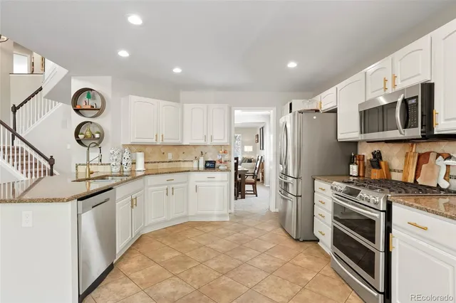 a kitchen with a sink stove and refrigerator