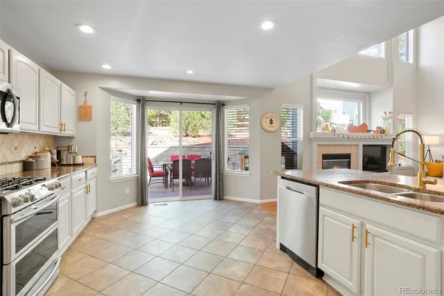 a kitchen with cabinets and chairs