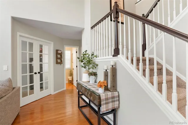 a view of an entryway wooden floor and a front door