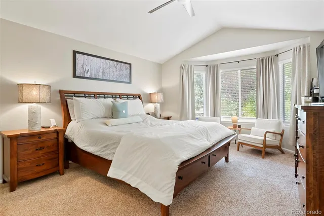 a spacious bedroom with a bed and a window