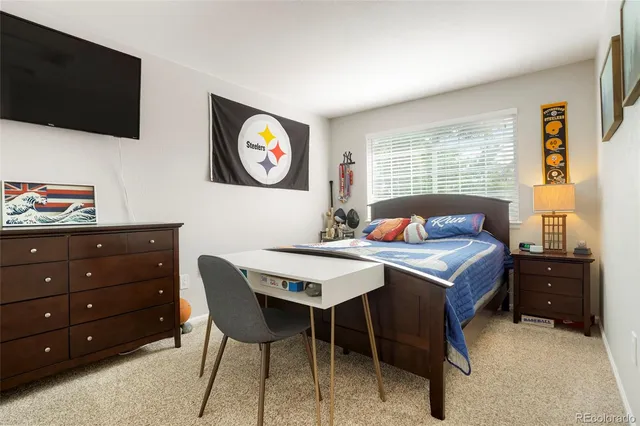 a bedroom with a bed and a television