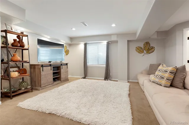 a bedroom with a large bed and a flat tv screen