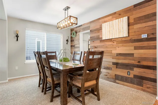 a view of a dining room with furniture and chandelier