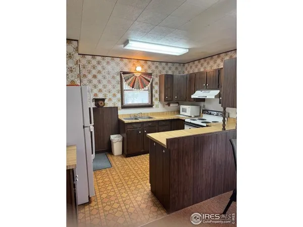 a kitchen with a sink cabinets and a window