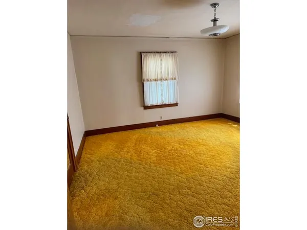 a view of an empty room with windows