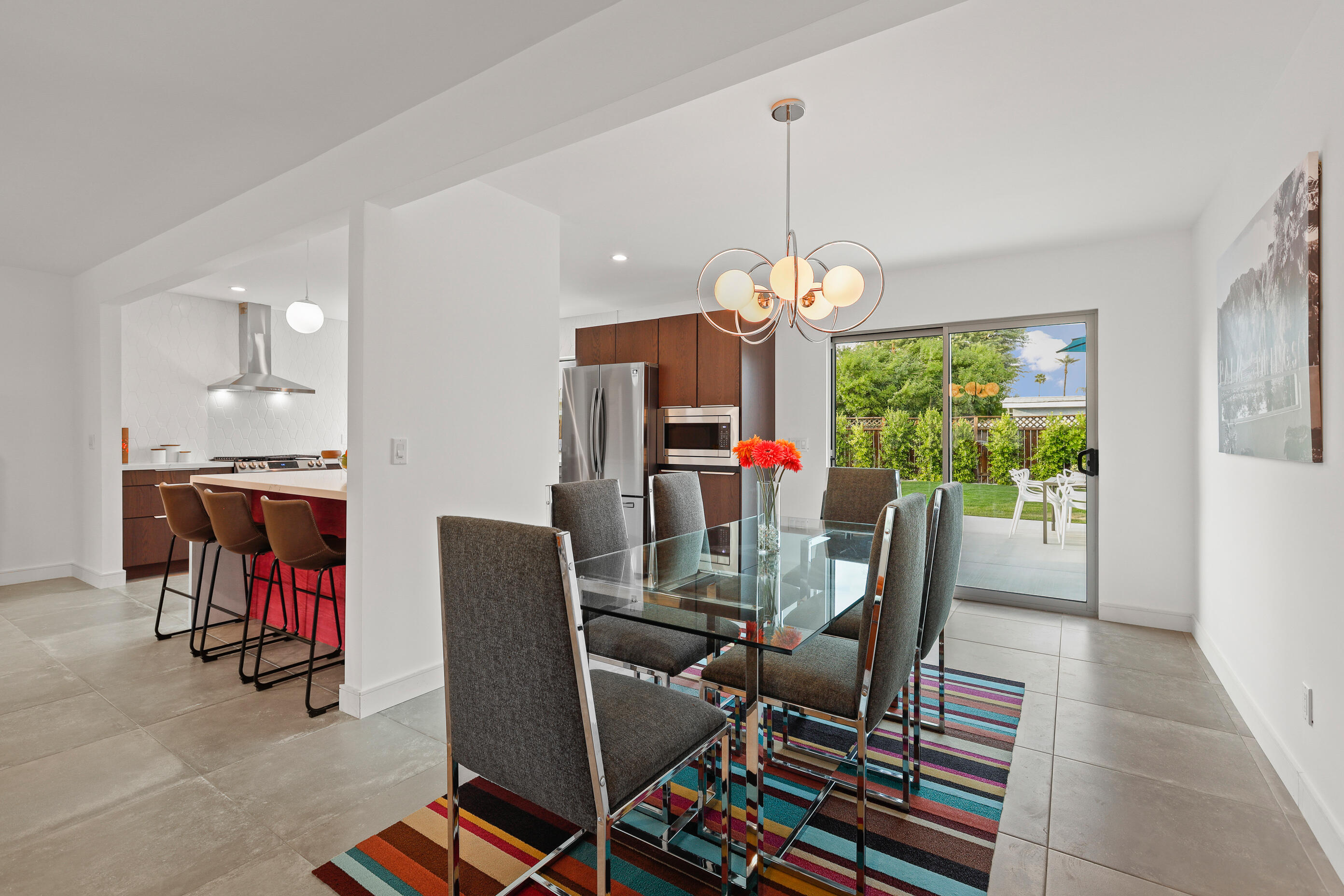 70170 Sun Valley Drive Rancho Mirage, CA 92270 - Photo 11 of 25 a dining room filled with furniture and a chandelier