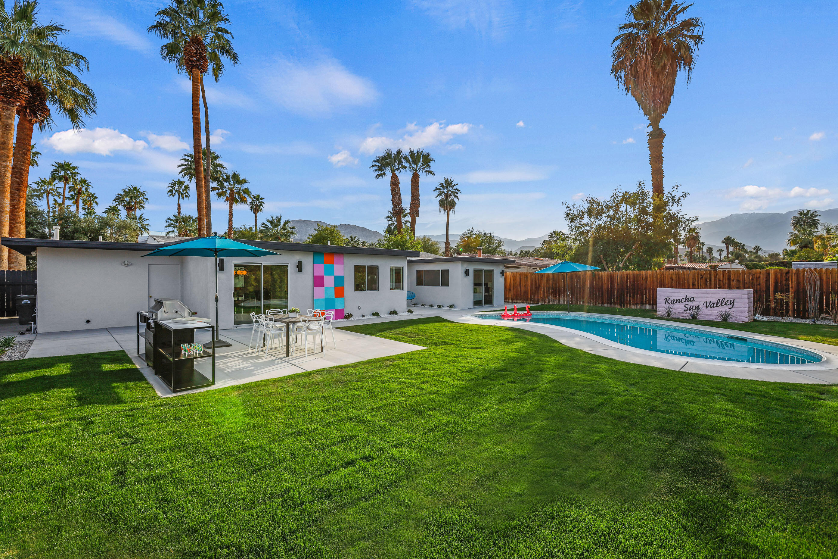 70170 Sun Valley Drive Rancho Mirage, CA 92270 - Photo 24 of 25 a view of a swimming pool with a table and chairs potted plants