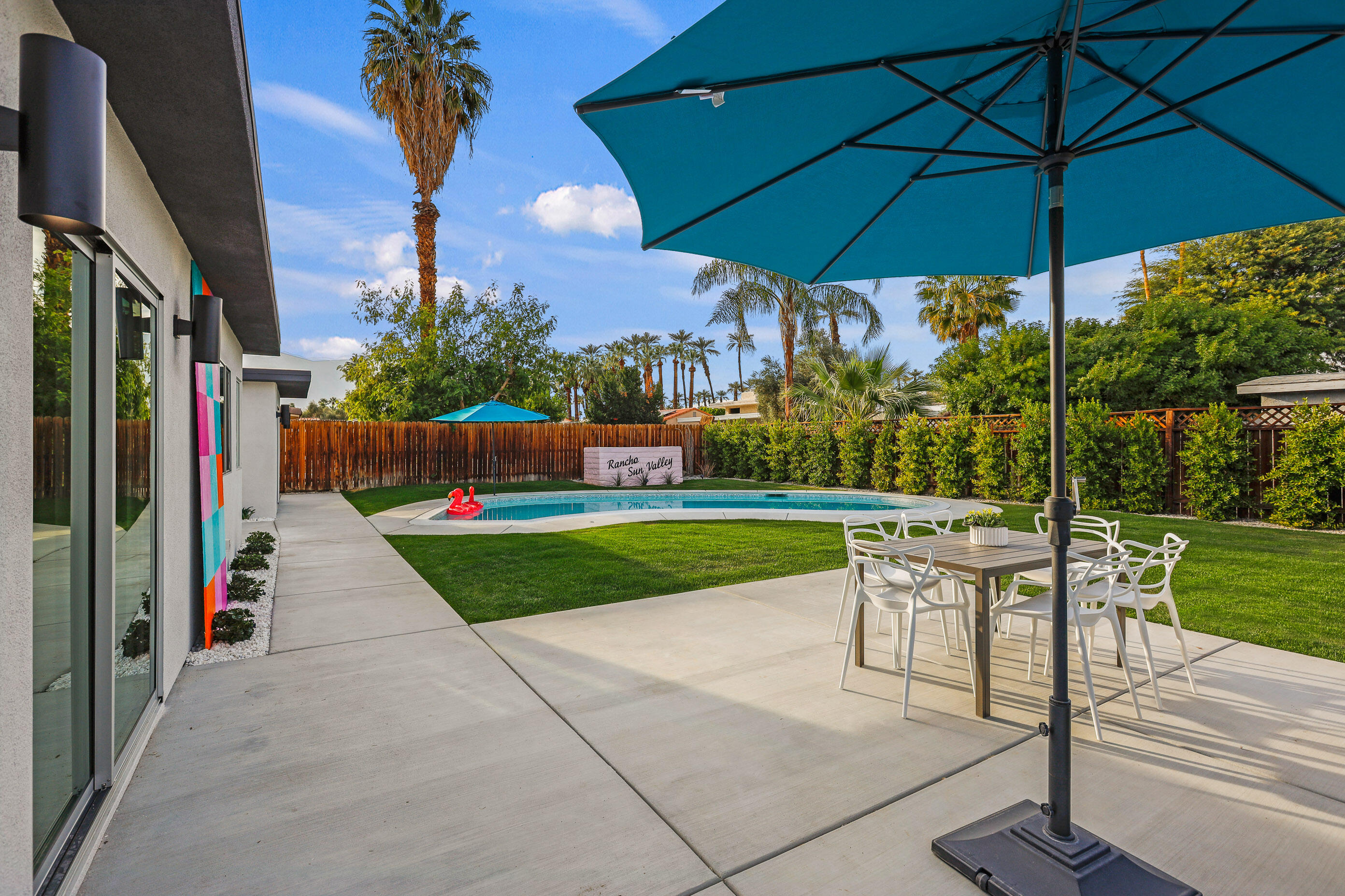 70170 Sun Valley Drive Rancho Mirage, CA 92270 - Photo 25 of 25 a view of a yard with table and chairs under an umbrella