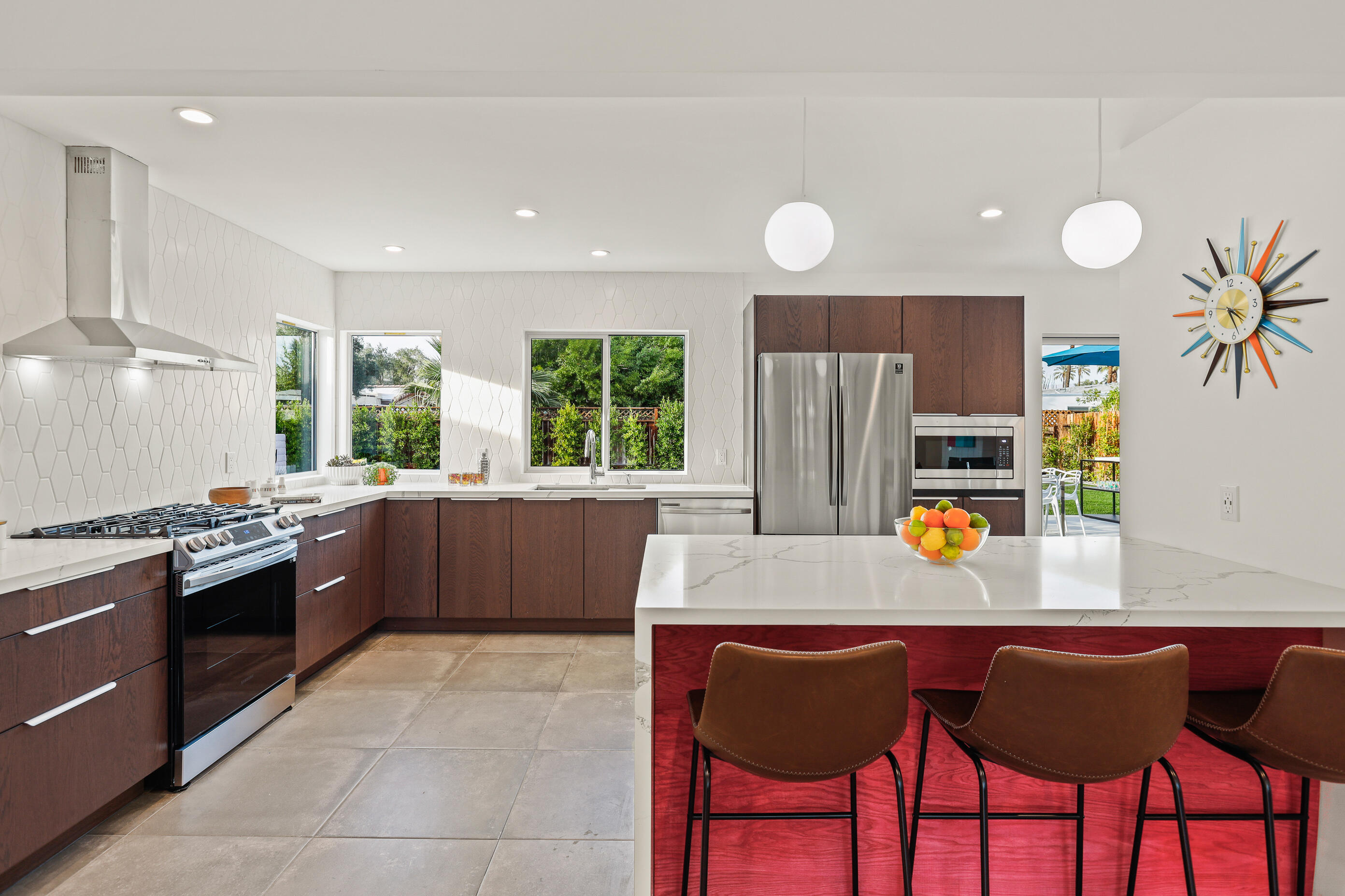 70170 Sun Valley Drive Rancho Mirage, CA 92270 - Photo 6 of 25 a kitchen with stainless steel appliances granite countertop a stove a sink a oven a dining table and chairs with wooden floor