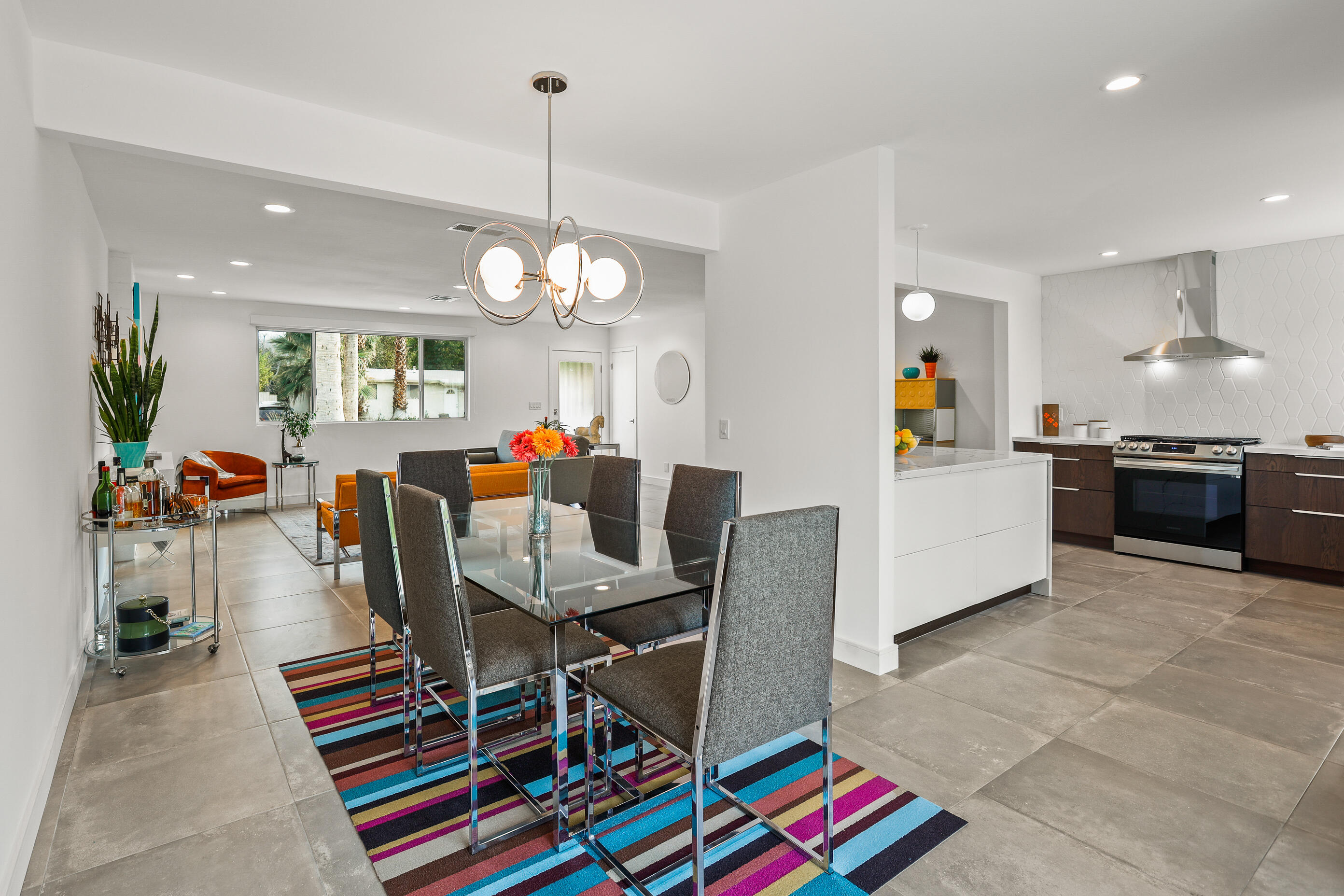 70170 Sun Valley Drive Rancho Mirage, CA 92270 - Photo 10 of 25 a dining room filled counter top space a dining table and a chandelier